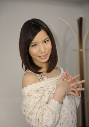 Youthful Japanese girl poses in short skirt that accentuates her long legs