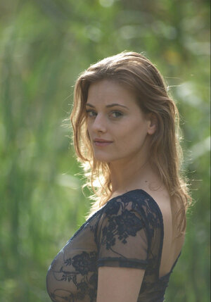 Sensual blonde is brave quite enough to have a stroll in light transparent dress