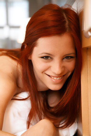 Chesty ginger hussy enjoys posing nude to show boobs and twat on the bed