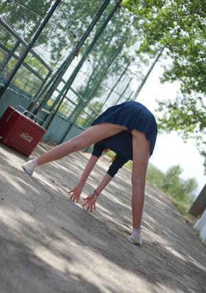 Hot red-haired cheerleader lifts skirt up to run into panties and nice ass