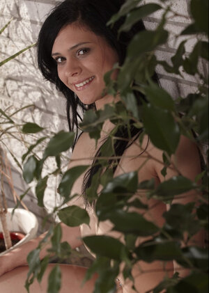 Tiny legal teen brunette displays her tiny boobies and charming pussy in the gym