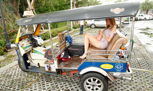 Clean-shaven fella and attractive Thai teenage have nice outdoor photoshoot near rickshaw
