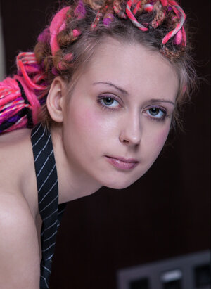 European minx with dreadlocks poses in the bedroom dressed only in a sexy necktie