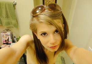 Teenage in floral swimsuit comes to bathroom where she takes pictures of naked body