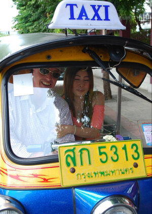 Joyful Thai minx poses near white fellow and additionally his impressive auto rickshaw