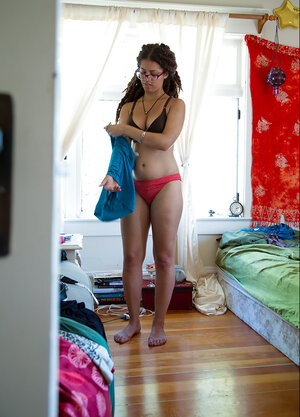 Geeky babe in glasses showing her meaty ass and moreover teasing likewise