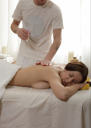 Tight bodied and besides oily babe gets fucked sideways on massage table