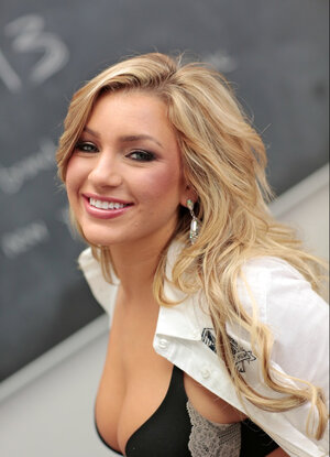 Smiling minx with great body shows off while in class