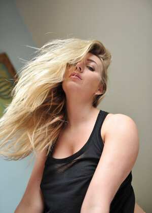 Hayley Coppin shows off her excellent hooters and also poses naked by the window