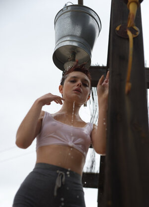 Short red-haired babe with freckles smokes after getting drenched