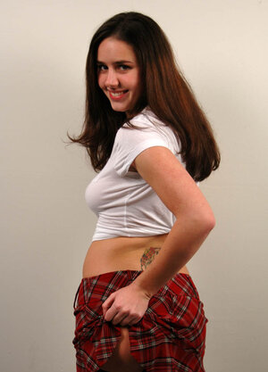 Long-haired schoolgirl Kacey Kox shows off her booty by lifting skirt