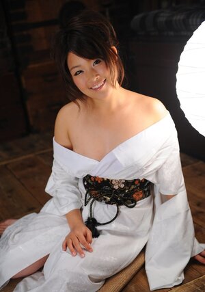 Gorgeous young Japanese woman in a kimono participates in erotic digital still session