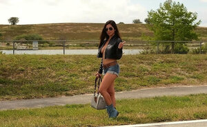 Floozy with sunglasses opens jacket demonstrating she doesn't wear bra