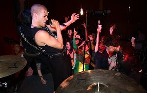 Gal is living it up at a rock concert and moreover as singer comes closer she kisses him