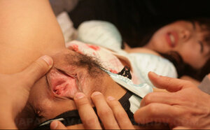 Young and fresh Japanese female with a gun in her hands is nailed by two perverts