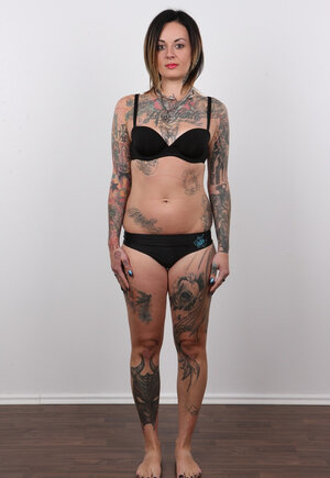 Diva with bright lipstick and additionally tattoos all over her body exposes shaved snatch