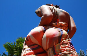 On a hot summer day the hottest brunette bares big fake bra buddies and plus big tooshie