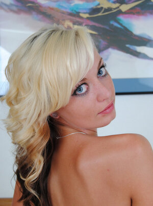 Beautiful blonde nympho gets rid of her underwear and demonstrates smooth pussy