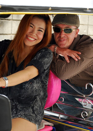 Clothed Thai babe with a cute face and red hair can brag about wonderful legs