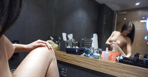 Bigtitted brunette poses undressed in font of the mirror after morning stretching