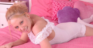 Underweight young wench in white gets on the bed and also strikes sexy positions